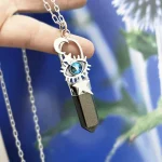 Joya espiritual en plata con ojo protector y obsidiana dorada
